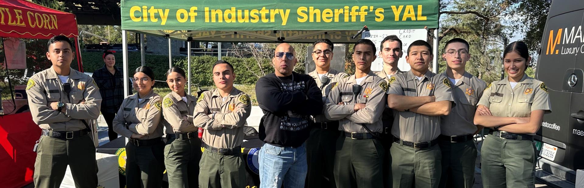 Group of Sheriffs Youth Program Members Posing Under Event Tent
